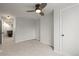 Hallway leading to a bedroom with ceiling fan and a bonus room with comfortable seating at 2336 N High St, Denver, CO 80205