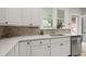 Bright kitchen features white cabinets, tile backsplash, stainless steel appliances, and a large window at 2336 N High St, Denver, CO 80205