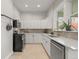 Bright kitchen featuring white cabinets, stone countertops, stainless steel appliances, and an outside entrance at 2336 N High St, Denver, CO 80205