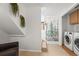 Bright laundry area with modern washer and dryer, plus convenient access to stairs at 2336 N High St, Denver, CO 80205
