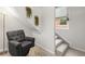 Sitting area with comfortable grey chair, ottoman, green hanging plants and window at 2336 N High St, Denver, CO 80205