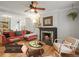 Cozy living room features a fireplace, ceiling fan, hardwood floors, and a comfortable seating area at 2336 N High St, Denver, CO 80205