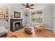 Living room featuring hardwood floors, a fireplace, and large windows that let in ample natural light at 2336 N High St, Denver, CO 80205