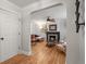 Living room featuring hardwood floors, a fireplace, and access from the entry hallway at 2336 N High St, Denver, CO 80205