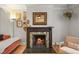 Fireplace and mantle featuring a decorative mirror, hardwood floors, and tasteful accents at 2336 N High St, Denver, CO 80205