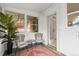 Inviting sunroom with lots of natural light from the many windows and 2 chairs with cushions at 2336 N High St, Denver, CO 80205