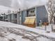 Blue multi-unit building with snow covered yard at 7185 S Gaylord St # G13, Littleton, CO 80122