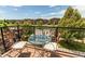 Outdoor balcony with chairs and table with a nice view of the neighborhood and trees on a sunny day at 2346 Central Park Blvd, Denver, CO 80238