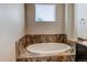 Close-up of the bathroom's soaking tub with a tile surround at 2346 Central Park Blvd, Denver, CO 80238