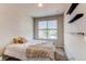 Bright bedroom features a cozy bed, window views, and contemporary shelving at 2346 Central Park Blvd, Denver, CO 80238