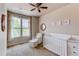 Bedroom featuring a crib, chair, and window with blinds at 2346 Central Park Blvd, Denver, CO 80238