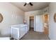 Bedroom with a white crib and ceiling fan at 2346 Central Park Blvd, Denver, CO 80238