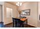 Elegant dining room with hardwood floors, wooden table, black chairs, decorative mirror and natural light at 2346 Central Park Blvd, Denver, CO 80238