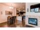 Open-concept dining area with a modern chandelier, a dining table with chairs, and hardwood floors at 2346 Central Park Blvd, Denver, CO 80238