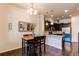 Dining area featuring a wooden table with black chairs, a decorative mirror, hardwood floors and modern lighting at 2346 Central Park Blvd, Denver, CO 80238