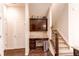 A hallway with a work desk and staircase has dark hardwood floors and neutral paint, offering storage at 2346 Central Park Blvd, Denver, CO 80238