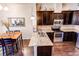 Modern kitchen features stainless steel appliances, granite countertops, dark wood cabinets, dining area, and hardwood floors at 2346 Central Park Blvd, Denver, CO 80238