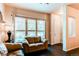 Bright living room featuring hardwood floors, a large window with blinds and two leather couches at 2346 Central Park Blvd, Denver, CO 80238