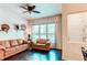 Cozy living room featuring hardwood floors, neutral walls, a ceiling fan and two leather couches at 2346 Central Park Blvd, Denver, CO 80238