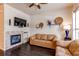 Inviting living room features a tiled fireplace, hardwood floors, stylish decor, and comfortable leather sofas at 2346 Central Park Blvd, Denver, CO 80238