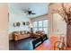Comfortable living room boasts hardwood floors, large window views, decor shelving, and cozy seating with a view of the front door at 2346 Central Park Blvd, Denver, CO 80238