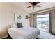 Bright bedroom with sliding glass doors to the balcony, complemented by neutral walls and modern decor for relaxation at 2346 Central Park Blvd, Denver, CO 80238