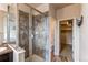 Bathroom with a glass enclosed shower with tile surround and view into the closet at 2346 Central Park Blvd, Denver, CO 80238