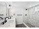 Elegant bathroom with double sinks, marble counters and tiled shower at 290 Beryl Way, Broomfield, CO 80020