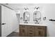 Updated bathroom with wood vanity, double sinks and tiled floor at 290 Beryl Way, Broomfield, CO 80020