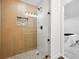 Modern bathroom with wood-look tile shower, glass door, and stylish fixtures at 290 Beryl Way, Broomfield, CO 80020