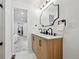 Bright bathroom featuring double sinks, wood vanity, and modern black hardware at 290 Beryl Way, Broomfield, CO 80020