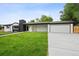 Contemporary home with lush lawn, painted brick, and attached garage with concrete driveway at 290 Beryl Way, Broomfield, CO 80020