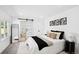 Serene bedroom featuring a sliding door to an ensuite bathroom and modern decor at 290 Beryl Way, Broomfield, CO 80020