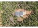 Aerial view of a house surrounded by trees with a long driveway and a gray roof at 510 Hill Dr, Sedalia, CO 80135