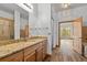 Bathroom featuring wood cabinets, a granite countertop, and tiled floors, along with a glass enclosed shower at 510 Hill Dr, Sedalia, CO 80135