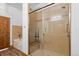 Modern bathroom featuring a glass enclosed shower with a built-in seat and grab bars at 510 Hill Dr, Sedalia, CO 80135