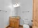 Bathroom vanity featuring wood cabinets, granite countertop, and toilet at 510 Hill Dr, Sedalia, CO 80135