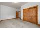 Bedroom with carpet, white walls, wooden trim, a window and a wooden double sliding door closet at 510 Hill Dr, Sedalia, CO 80135