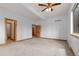 Large, carpeted bedroom featuring two doorways and two windows at 510 Hill Dr, Sedalia, CO 80135