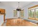 Light-filled dining room showcasing hardwood floors and expansive windows with wooded views at 510 Hill Dr, Sedalia, CO 80135