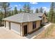 Charming home with a large two-car garage, concrete driveway, and mature landscaping at 510 Hill Dr, Sedalia, CO 80135