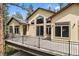 Stunning stucco home with a spacious deck, complemented by large windows and mature trees at 510 Hill Dr, Sedalia, CO 80135
