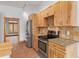 Bright kitchen featuring wood cabinets, stainless steel appliances, and stone countertops at 510 Hill Dr, Sedalia, CO 80135
