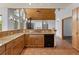 Bright kitchen featuring a wood ceiling, granite countertops, wood cabinets, and stainless steel appliances at 510 Hill Dr, Sedalia, CO 80135