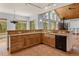 Well-equipped kitchen boasts wood cabinets, granite countertops, and views into the great room at 510 Hill Dr, Sedalia, CO 80135