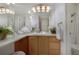 Bright, spacious bathroom with a large mirror, and a vanity with a blond cabinet at 9160 E Arbor Cir # F, Englewood, CO 80111