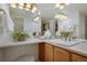 Bright, spacious bathroom featuring double sinks and a large mirror above the vanity at 9160 E Arbor Cir # F, Englewood, CO 80111