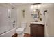Bathroom featuring a shower-tub combo and a vanity with a brown cabinet at 9160 E Arbor Cir # F, Englewood, CO 80111