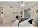 Bedroom featuring a ceiling fan, neutral walls, and sliding glass door to balcony at 9160 E Arbor Cir # F, Englewood, CO 80111