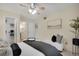 The bedroom includes a ceiling fan, neutral walls, and access to a closet and bathroom at 9160 E Arbor Cir # F, Englewood, CO 80111